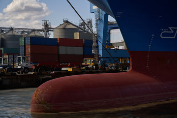 Container ship in port at container terminal. Ships of container ships stand in terminal of port on...