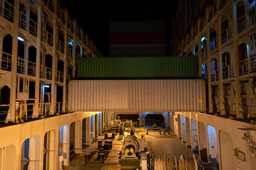 Container ship in port at container terminal. Ships of container ships stand in terminal of port on loading, unloading container at night time.