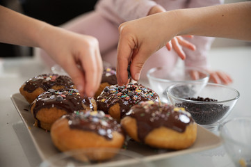 Children decorating home made doughnuts