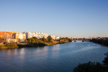 Fototapeta na wymiar Guadalquivir River. Panoramic view of the waterfront of the Guadalquivir River in Seville, Andalusia, Spain. Picture taken 22 march 2020.