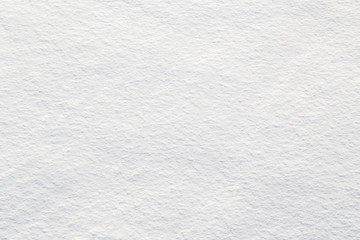 Obraz premium Close-up of a snow texture with a rough, grainy surface. The soft, clean, uneven pattern captures the natural feel of freshly fallen snow, ideal for backgrounds or winter-themed designs.