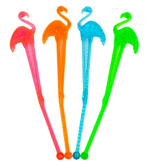 Isolated red, green, orange and blue plastic flamingo cocktail stirrers. © Noel