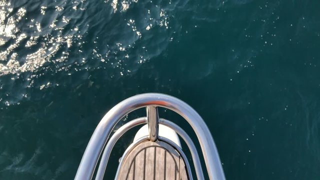 White Sailing Catamaran Yacht walking near Jeju island. Surf, waves and rocks from yacht boat.