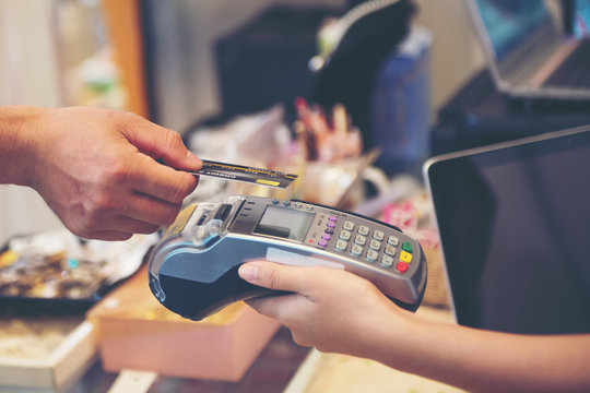 Close up Hand Swiping Credit Card In Store 