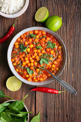 Indian meal, spicy chickpea curry with spinach in a bowl served with rice