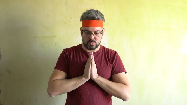 Bearded man against the wall. Good mood. Engaged in martial arts. Repair work in the room. Frick.