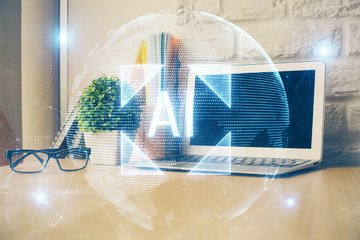 Double exposure of desktop computer and technology theme hologram. Concept of software development.