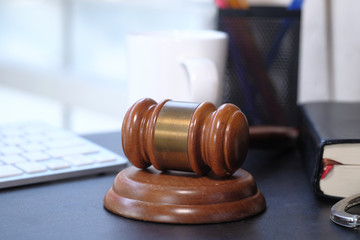 Close up of gavel , book and handcuff on table 