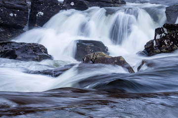 the waterfalls in Glen Orchy near Bridge of Orchy in the Argyll region of the highlands of Scotland during winter whilst the river is flowing fast from rainfall © Andy Morehouse