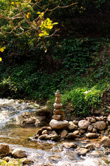 Rock Stack, Stone Cairn Along Sign Small River in the Beautiful Forrest.