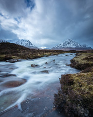 the river coupall waterfalls on rannoch moor showing buachaille etive mor in the background as the entrance to glencoe valley in winter