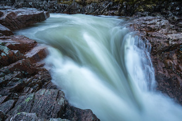 the river coupall waterfalls on rannoch moor showing buachaille etive mor in the background as the entrance to glencoe valley in winter