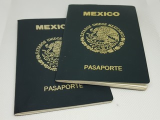 Two Mexican passports in a white background 