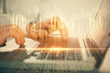 Double exposure of market chart with man working on computer on background. Concept of financial...