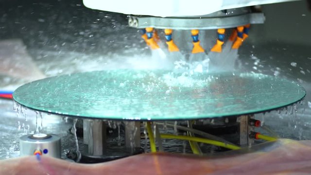 slow motion, CNC machine polishing mirror by water and specialist technical equipment, close up,