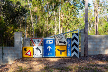 Random signs attached to a farm gate near Tinaroo Falls Dam in Queensland, Australia