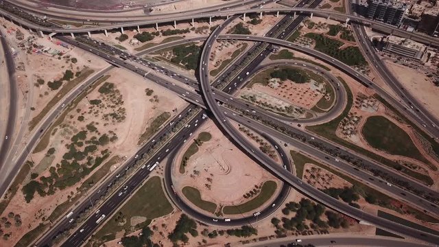 Tilting aerial view of busy highway during rush hour traffic in Riyadh, infrastructure transportation economy Saudi Arabia