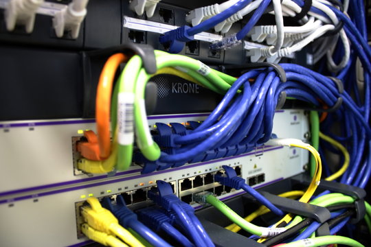 Ethernet cables and fiber optic cable plugged into servers