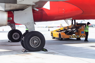 Preparing for the flight of an airliner. Close-up of airplane preparing for departure, landing gear check