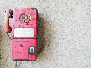 Old red payphone on wall with copy space