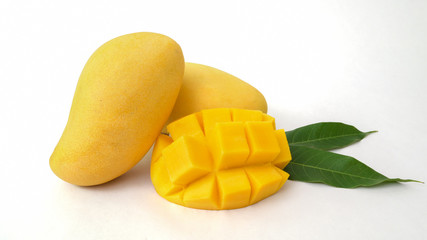 Close up view of mangoes fruit and mango cut in cubes isolated on white background