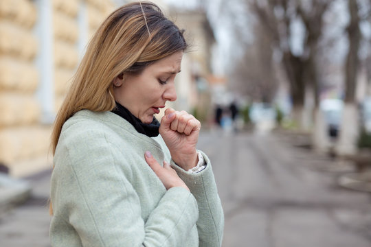 young woman coughing feeling bad