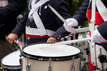Young man playing snare drum in celebration of independence, military march, parade in Latin America in September.