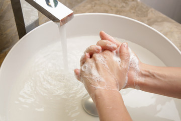 Hygiene. Cleaning hands with soap and water. Washing hands on sink. Preventing diseases by washing...