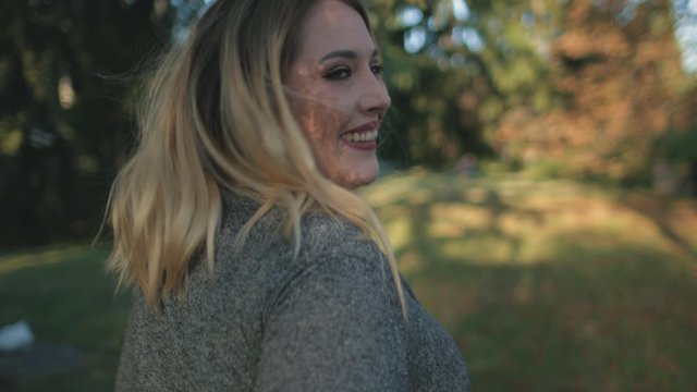 Attractive Blonde Woman Plus Size Walk City Park. Happy Caucasian Lady Smile Happy Moments Stroll about Urban Parkland. Female Adult Turn Round Movements Leisure Activity Slow Motion 4K