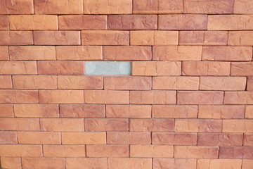 Red grunge brick wall with one missing brick. Incomplete brick wall background