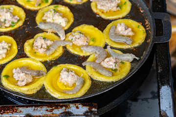 Vietnamese cuisine- sizzling tiny shrimp pancake on skillet, Banh Khot
