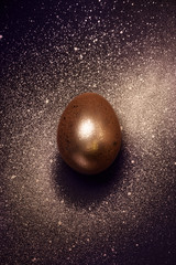 Golden egg and paint spray Galaxy. Abstract cosmos with golden egg planet