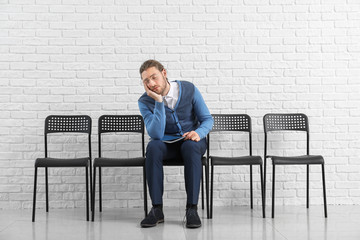 Young man waiting for job interview indoors