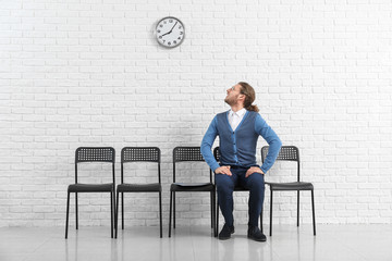 Young man waiting for job interview indoors
