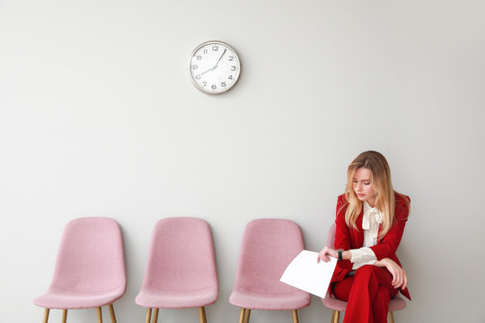 Young woman waiting for job interview indoors