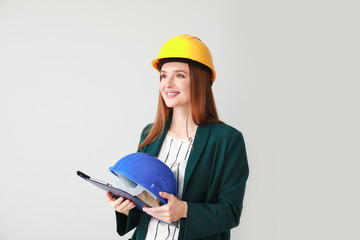 Female engineer on light background