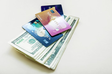 Dollar banknotes with credit cards on light background