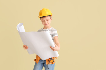 Cute little architect on light background