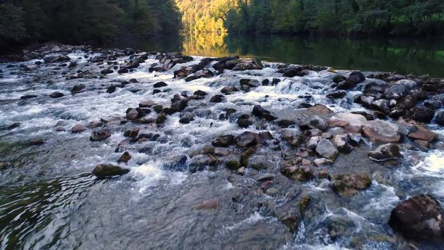 Low angle view of the Kolpa river, Kostel. water splashes over and around rocks