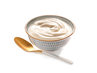 Bowl with tasty yogurt and spoon on white background