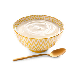 Bowl with tasty yogurt and spoon on white background