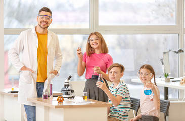 Teacher conducting chemistry lesson in classroom