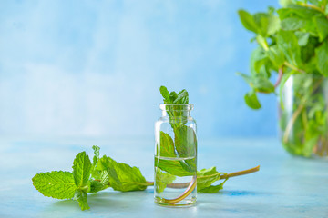 Bottle of mint essential oil on table