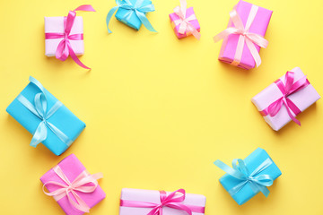 Frame made of Birthday gifts on color background