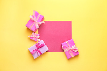Blank card and Birthday gifts on color background