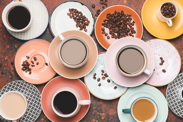 Composition with cups of different coffee on grunge background