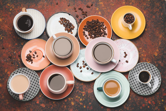 Composition with cups of different coffee on grunge background © Pixel-Shot