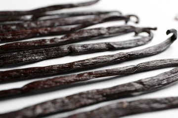 Aromatic vanilla sticks on white background, closeup