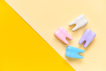 Plastic teeth on color background