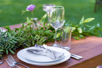 Preparing for an open-air party. Decorated with fresh flowers served tables. Table number. Decoration Details